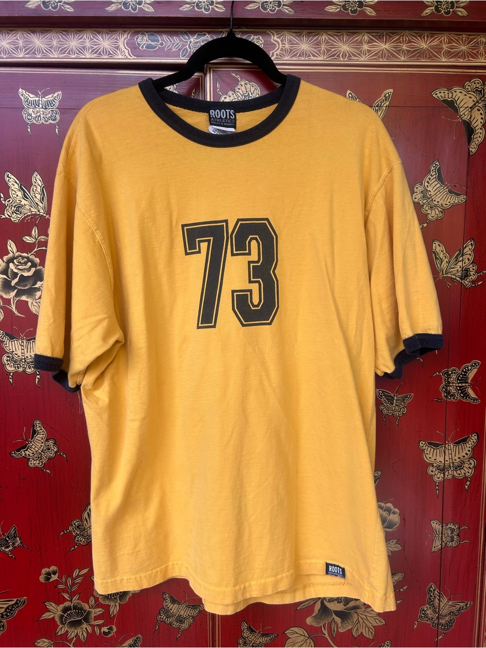 Roots Men’s Mustard Yellow Ringer Tee with Black Trim and '73 Graphic